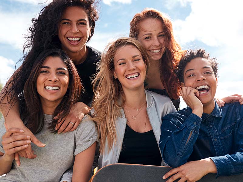 Group of female friends smiling together outdoors