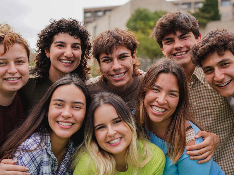 Group of young adults smiling together outdoors